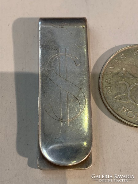 Silver money clip with dollar sign