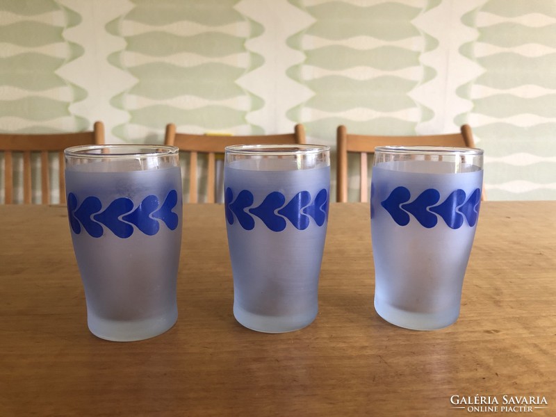 Old sandblasted small glasses with a blue pattern