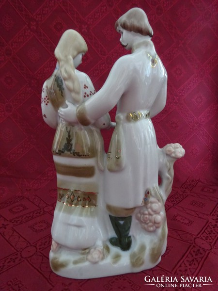 Russian porcelain figurine, a couple in love in folk costume, height 25 cm. He has!