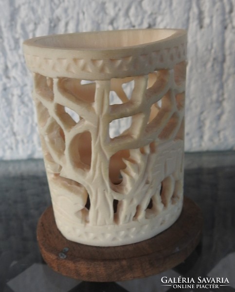 Carved bone on a wooden pedestal - ornament