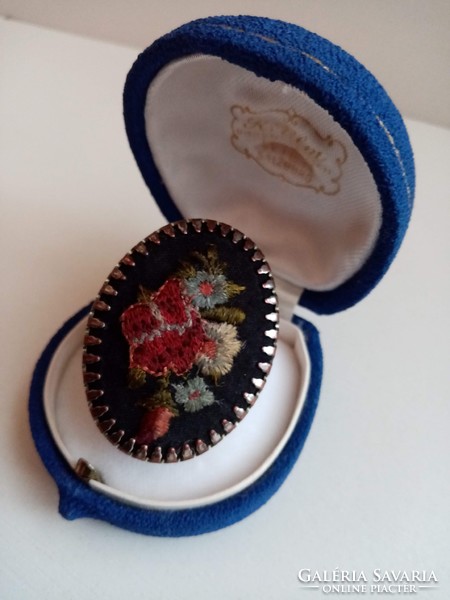 Old ring adorned with embroidered handmade embroidery