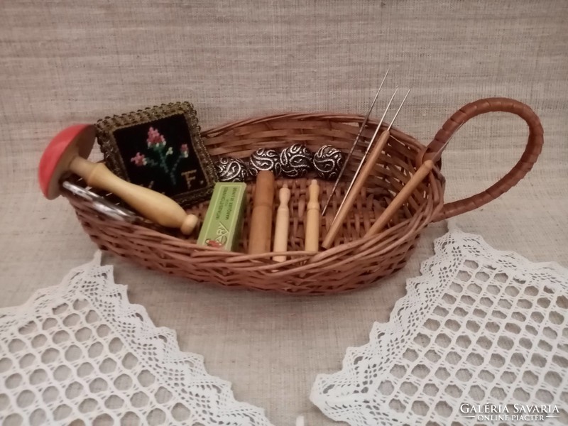 Old wicker basket inside crocheted tablecloth crochet needle with wooden needle holder pincushion wooden ornament buttons scissors
