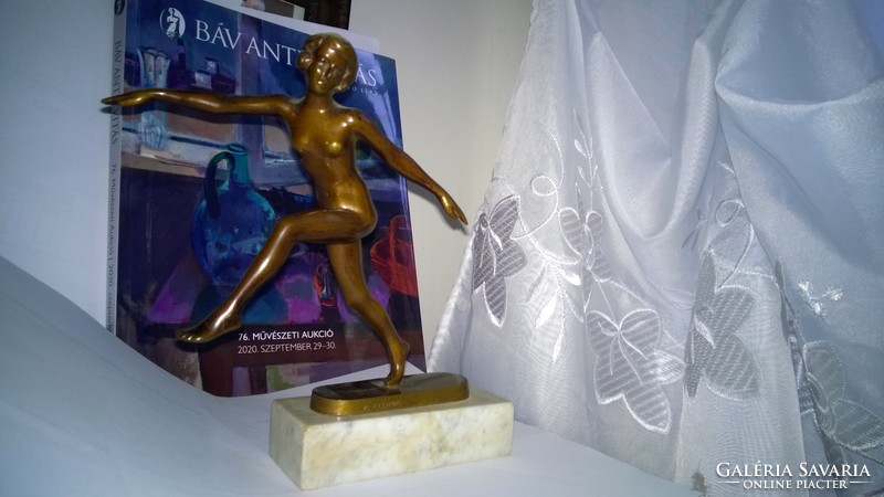 Bronze gymnast nude on marble sole. Statue