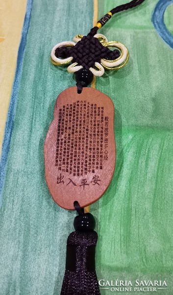 Real room. Rosewood pendant, amulet, kuan yin