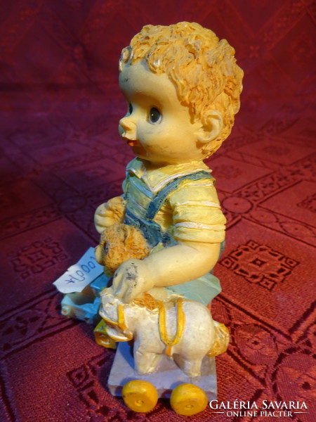 Figural statue of the little boy with his toys, height 9.5 cm. He has!