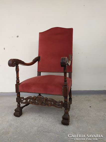 Antique richly carved renaissance chair with throne