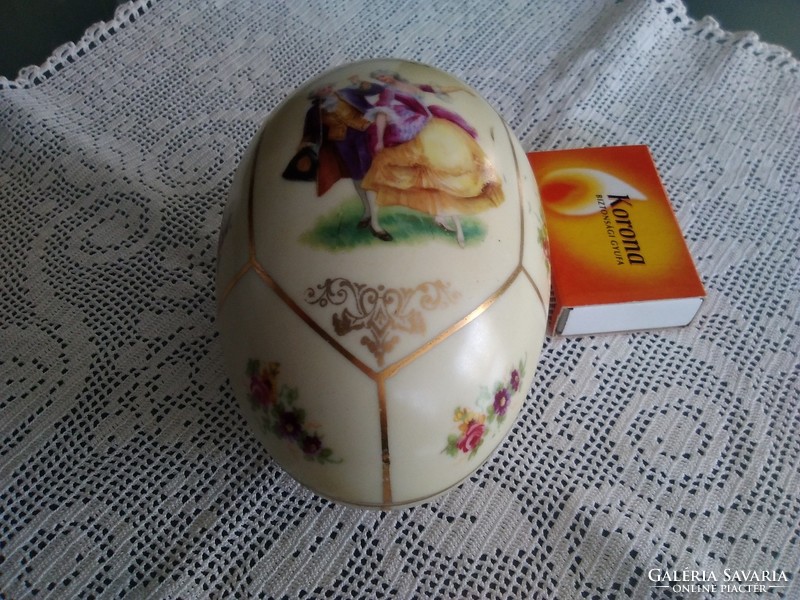 Old cream-colored porcelain egg with a hand-painted scene and a number pressed into the mass!