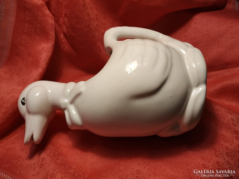 Porcelain duck, watering can, pouring