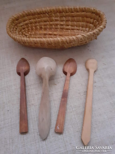 An old handmade mat basket with a carved wooden spoon