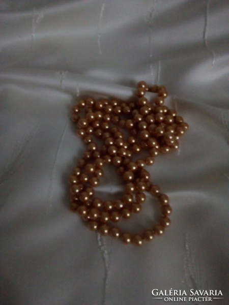 A long string of golden brown pearls