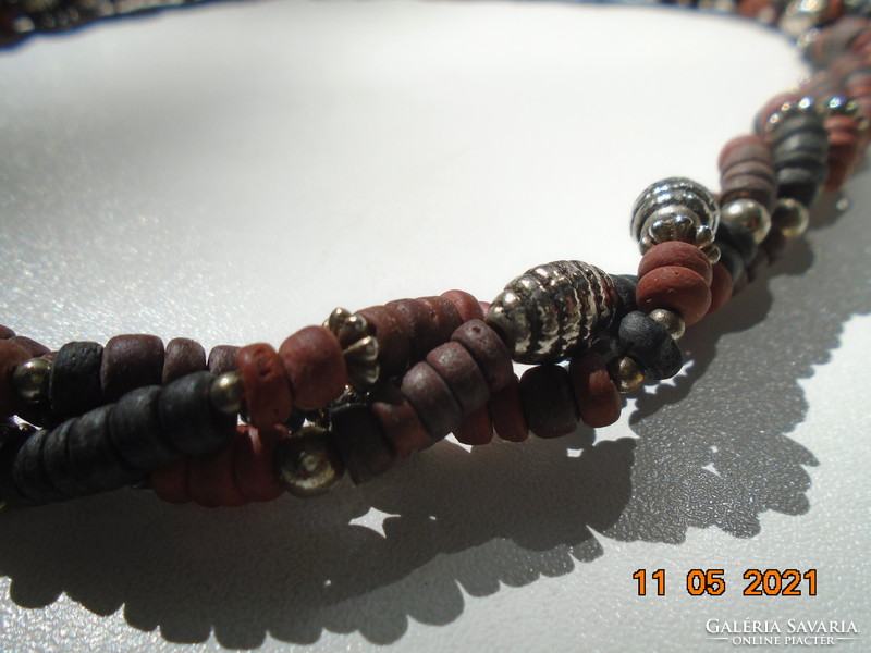 Tribal three-row twisted necklaces made of smaller multi-colored sandalwood and larger silver-colored metal beads