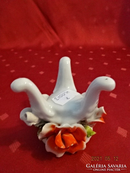 German porcelain, three-legged candlestick with rose pattern. He has!
