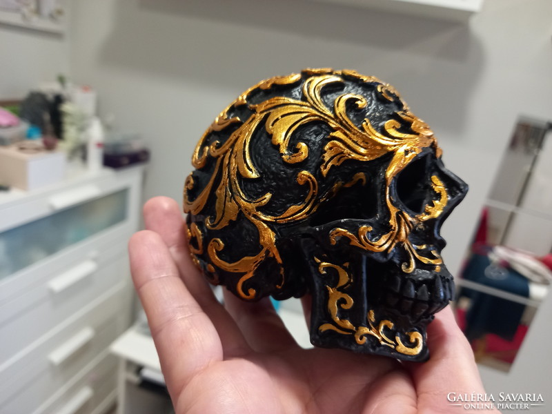 Richly decorated black realistic skull with a special ornamental motif