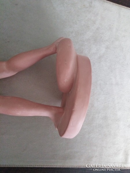 Spherical ceramic sculpture of a female nude