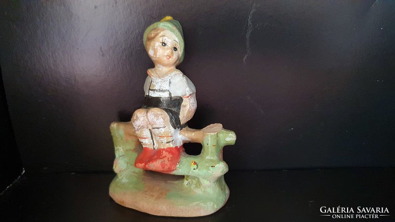 Antik, kerítésen ülő, kerámia kisfiú figura.