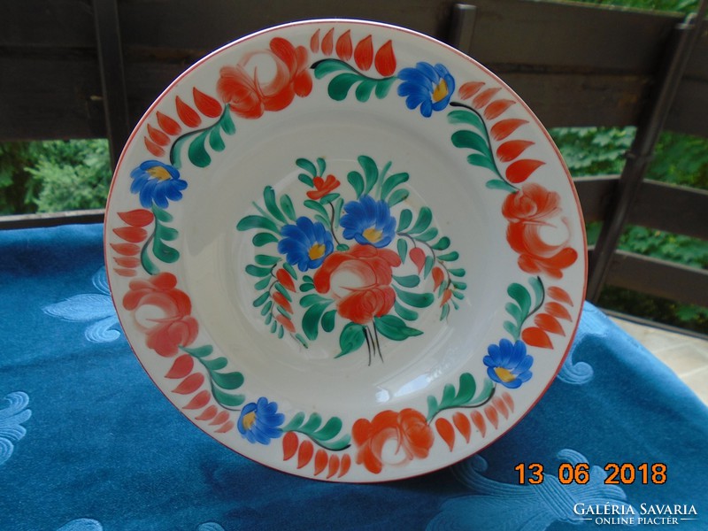 Hand-painted porcelain wall plate with a rich floral pattern
