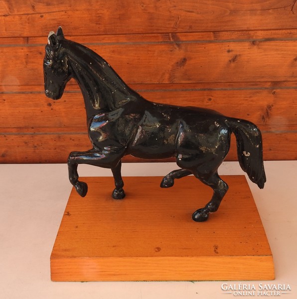 A large horse statue on a wooden pedestal