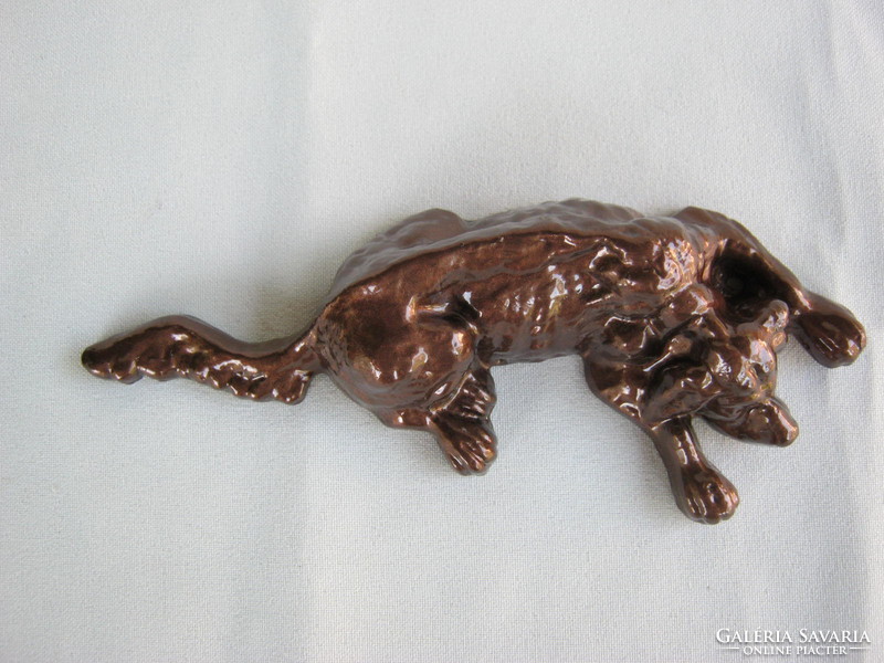 Reclining dog metal sculpture