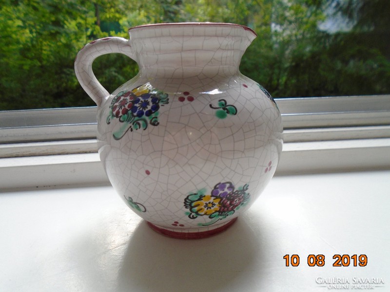 Signed majolica jug with hand-painted floral pattern and cracked glaze