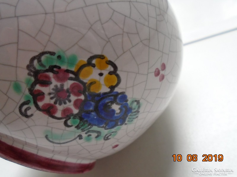 Signed majolica jug with hand-painted floral pattern and cracked glaze