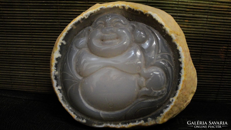 It contains opal stone, closed geode, water with Buddha carving