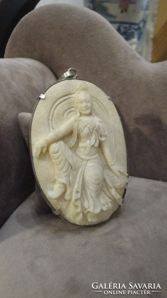 Silver pendant with fish bone carving