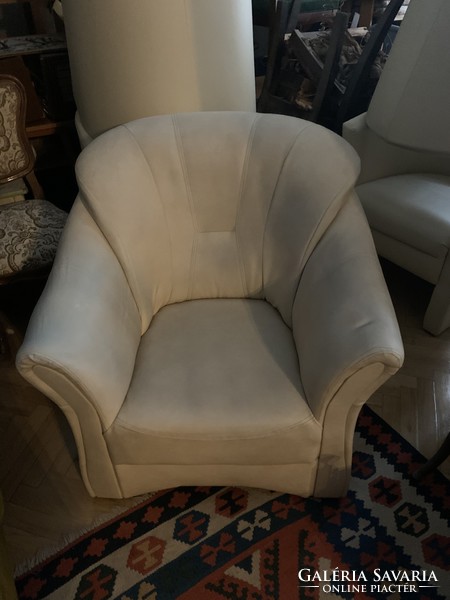 Beige (sometimes pale blue) leather armchair