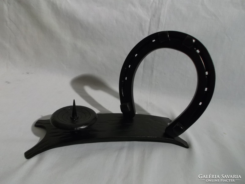 Old lucky horseshoe and candlestick made of iron