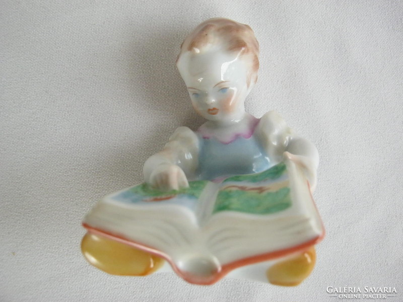 Retro ... Little girl looking at herend porcelain picture book