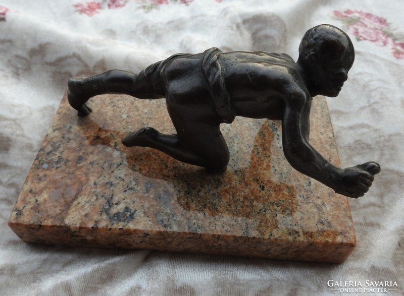Athlete - bronze statue on a marble pedestal
