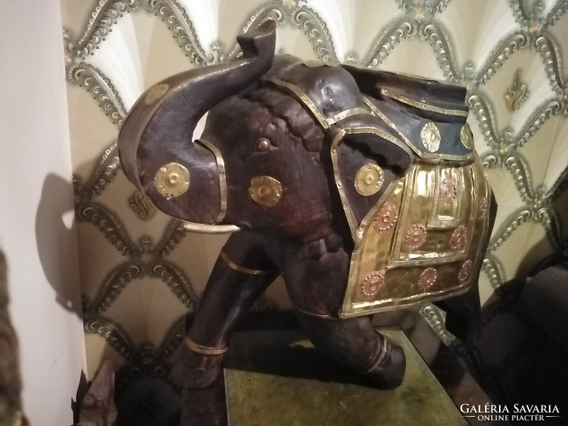 Antique wooden elephant with copper decoration