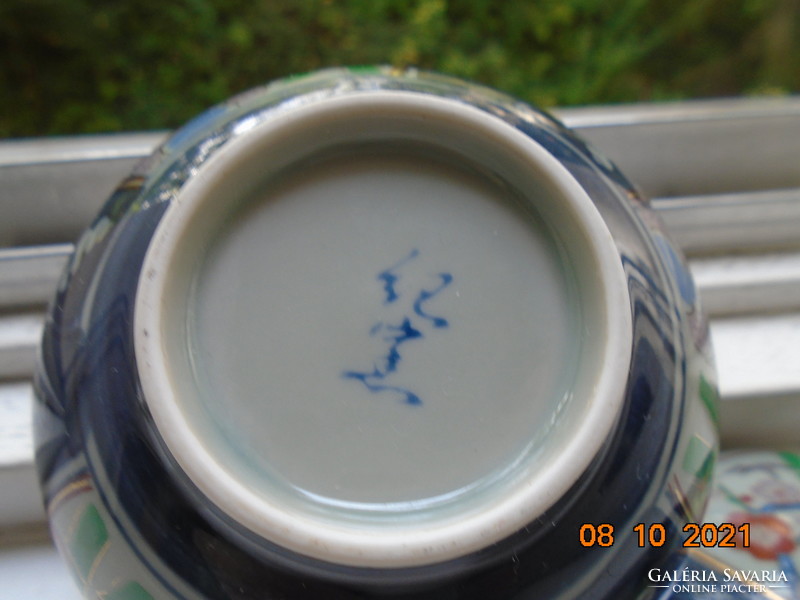 Hand-painted, hand-marked cup with imari and blue white flower patterns on gray jade glaze