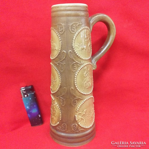 German hunter scene ceramic beer mug with drum pattern. 21 cm.