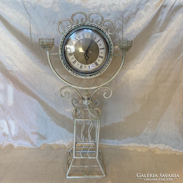Antique metal candlestick with clock
