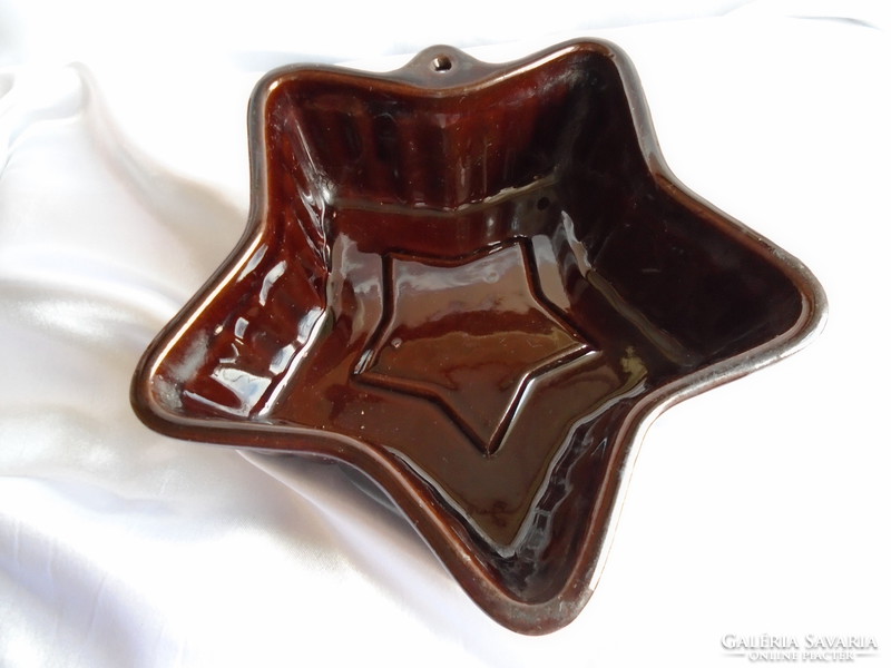 Star-shaped, beautifully patterned glazed ceramic baking dish.