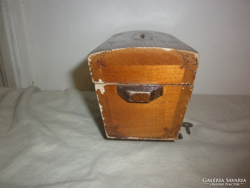 Old wooden money box with tiny padlock