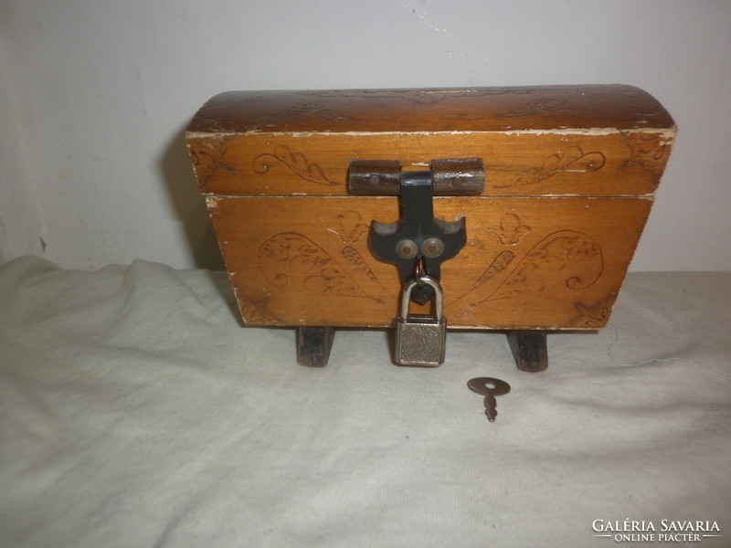 Old wooden money box with tiny padlock