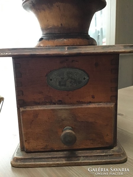 Antique wooden coffee grinder with porcelain interior