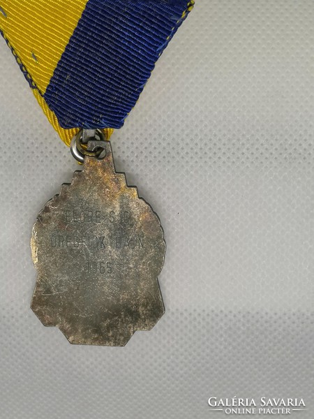 Old sports medal with chest strap 1965