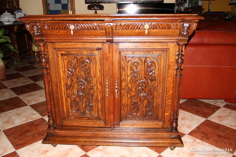 Old German richly carved oak chest of drawers