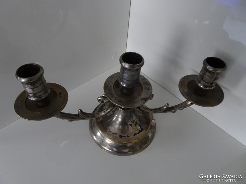 Three-pronged silver-plated candlestick.