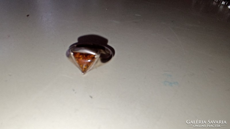 Silver ring decorated with amber stone. 925