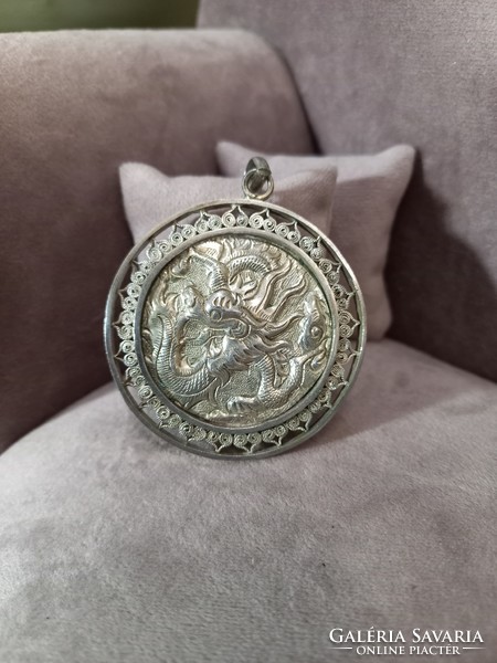 Silver pendant with dragon