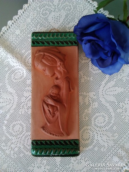 Mary is a terracotta wall picture with your little Jesus, with green ceramic glaze decoration on the top and bottom!