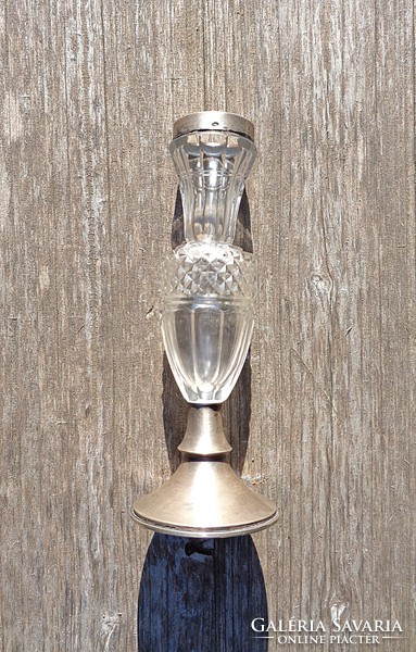 Old polished glass crystal vase with silver rim above