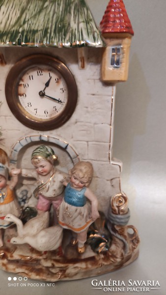 Rare German porcelain richly gilded castle-shaped clock with charming children's figures