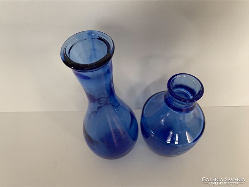 Two old blue bottles, 20 and 14 cm respectively.