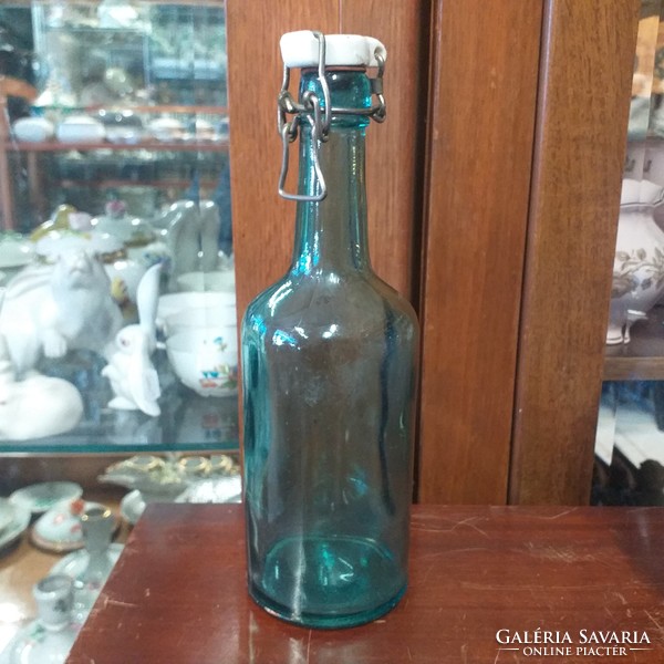 Porcelain buckle blue glass bottle. Arnas indicated. 23 Cm.