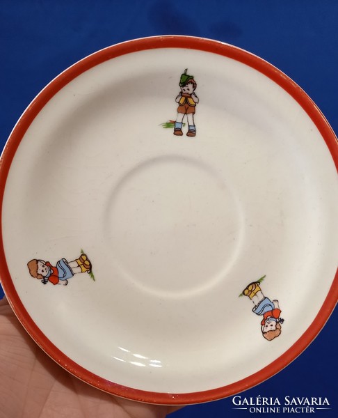 A saucer depicting a little girl and a little boy