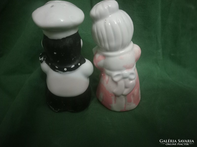 Chef aunt and cook spraying salt and pepper